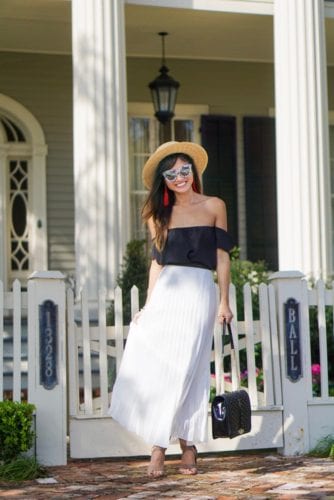 jumbo love cross body bag, white pleated skirt, boat hat, red tassel earrings