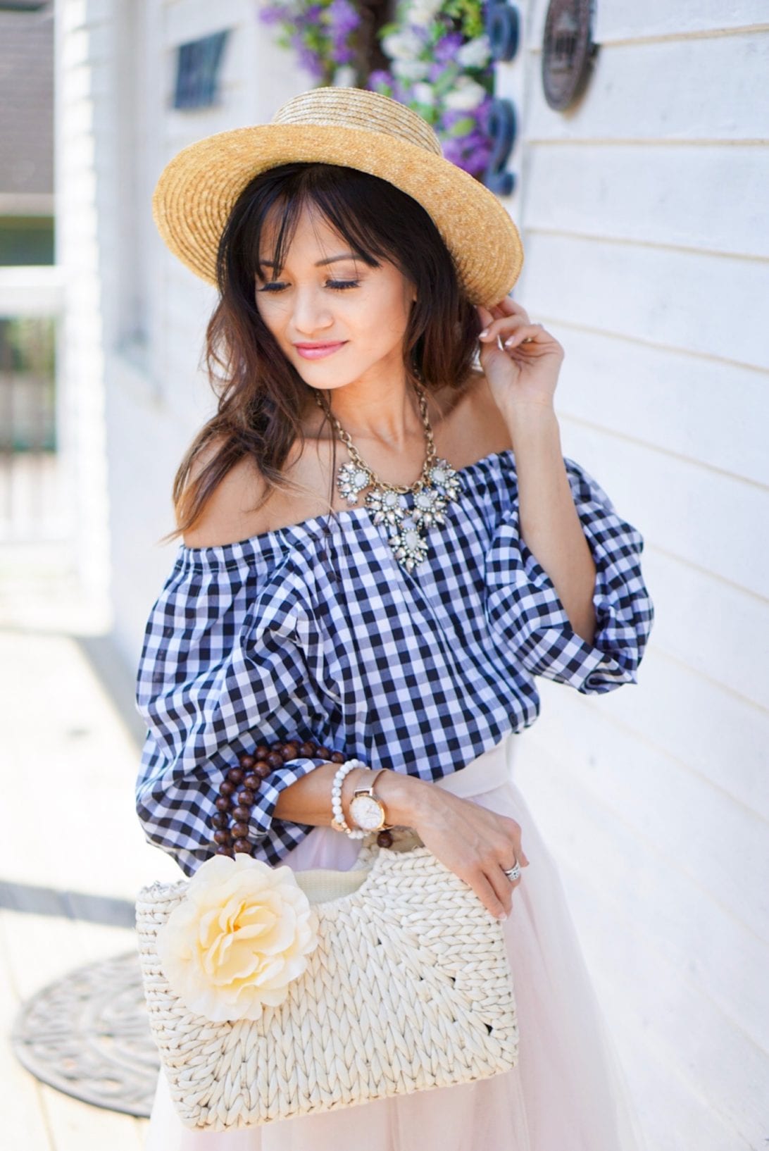 off the shoulder top, gingham top, floral straw bag, straw hat, statement necklace, tulle skirt