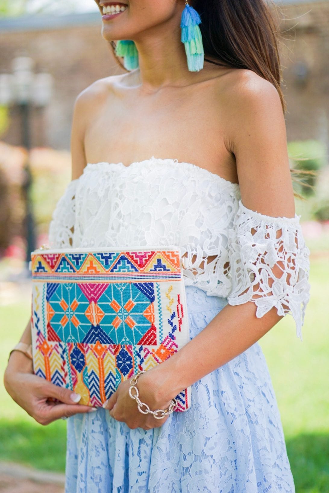 off the shoulder top, embroidered clutch, ombre earrings