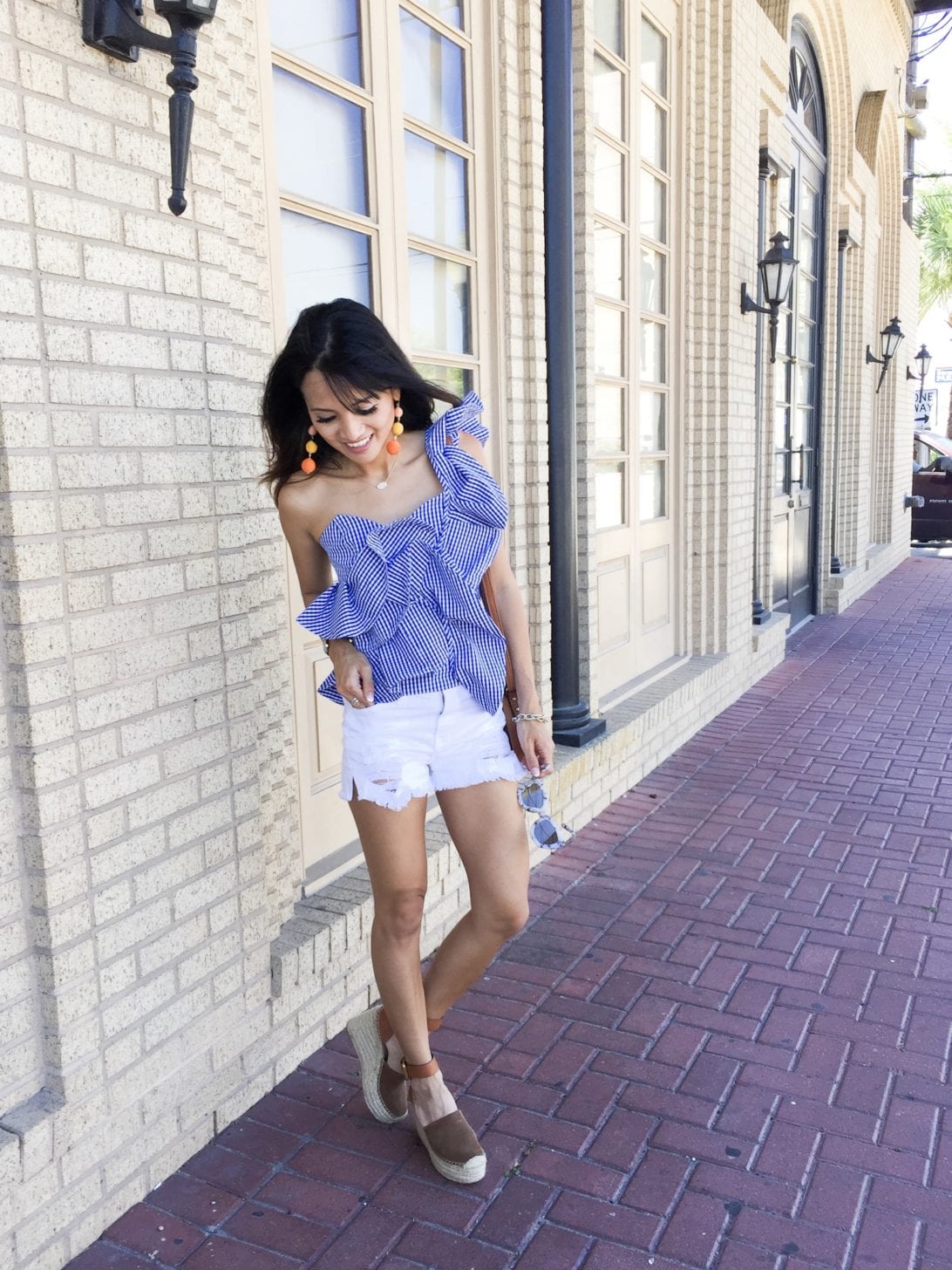 ONE-SHOULDER GINGHAM RUFFLE BLO-- USE, white shorts, marc fisher wedges, quay sunglasses, charming charlie, austin earring