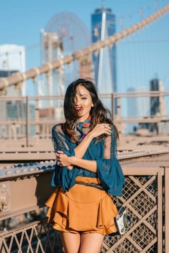 NYFW, NYFW OUTFIT, NYFW STREETSTYLE, New York FASHION WEEK, NYFW 2017, BROOKLYN BRIDGE, BROOKLYN BRIDGE PHOTO SHOOT, AGACI, SATIN SKIRT, RUFFLE TOP, BLACK STUDDED BOOTIES. SCARF, TIE SCARF, CAMERA BAG