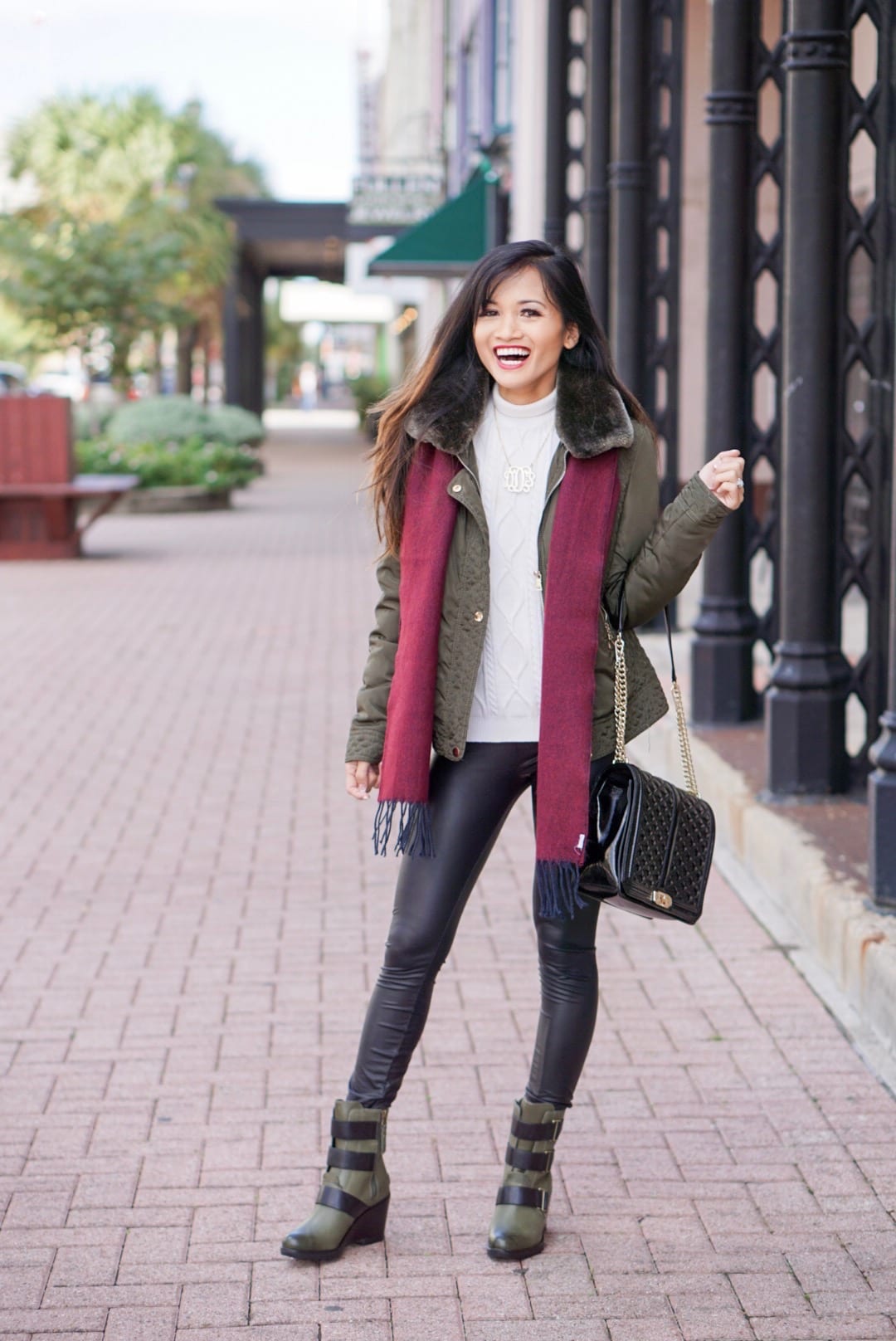 Sorel boots, holiday packing list, vacation packing list, winter packing list, faux leather pants, green puffer jacket 