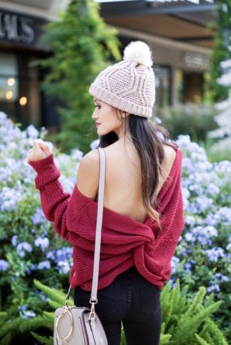 knot back sweater, pom pom beanie, studded boots, black ripped jeans, Chloe dupe bag, winter style, winter fashion. holiday outfit, winter outfit, christmas gift guide, gifts under $50