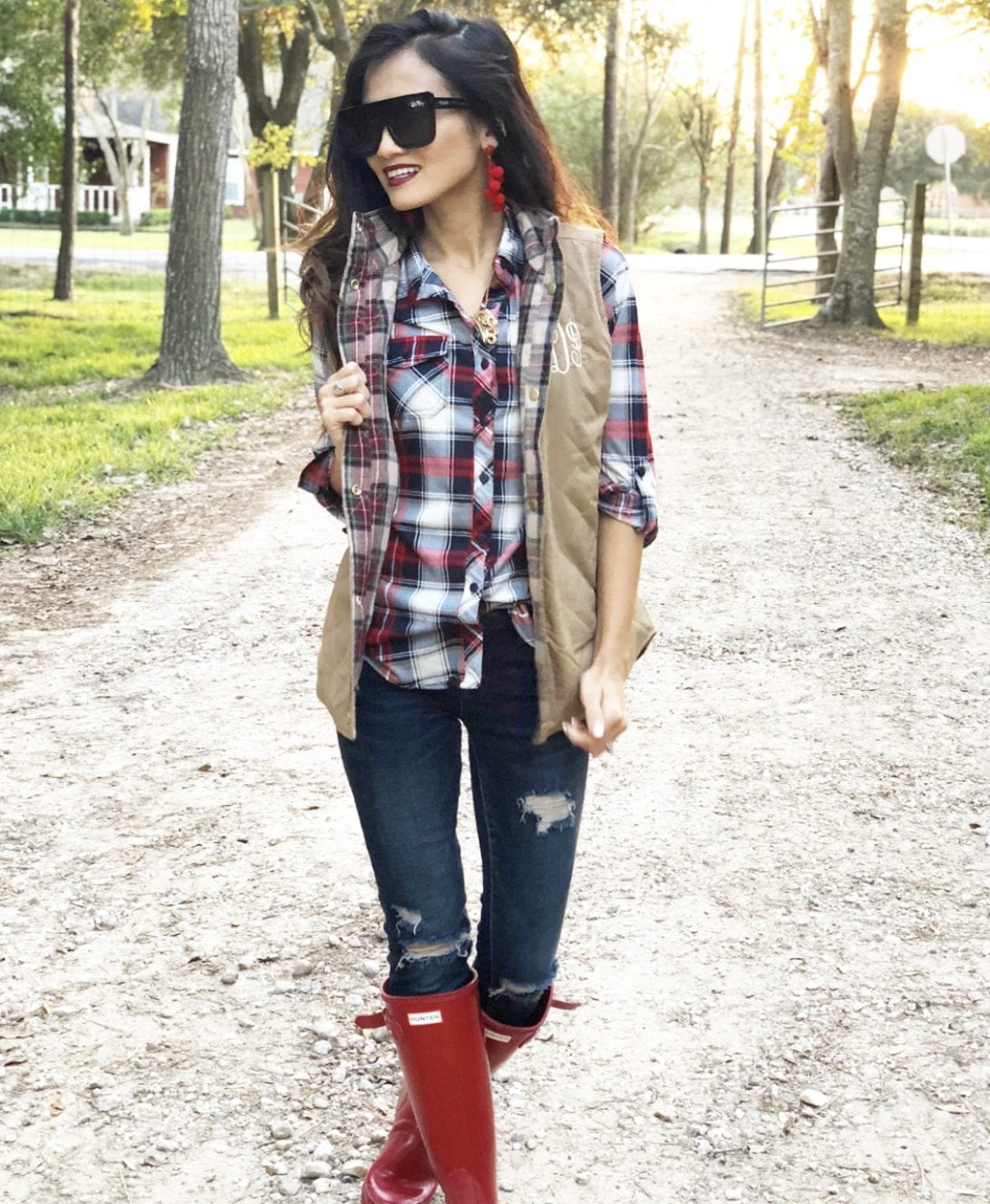 hunter boots, hunter boots outfit, holiday outfits, how to wear hunter boots, christmas outfits with hunter boots, gift guide for her, red hunter boots, hunter boots for the holidays, monogrammed vest, quay cafe racer, red bauble bar earrings, blank NYC jeans, red plaid shirt