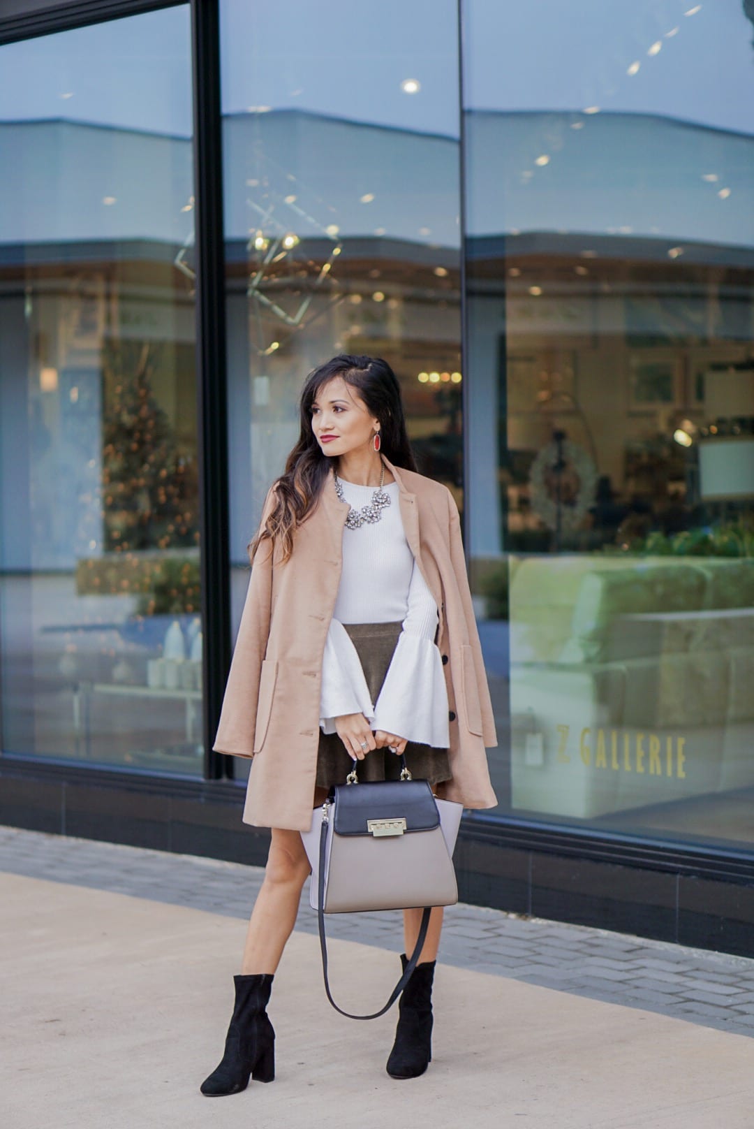 camel coat, corduroy skirt, black sock booties, winter outfit, white bell sleeve top, Zac Posen bag, red Kendra Scott earrings