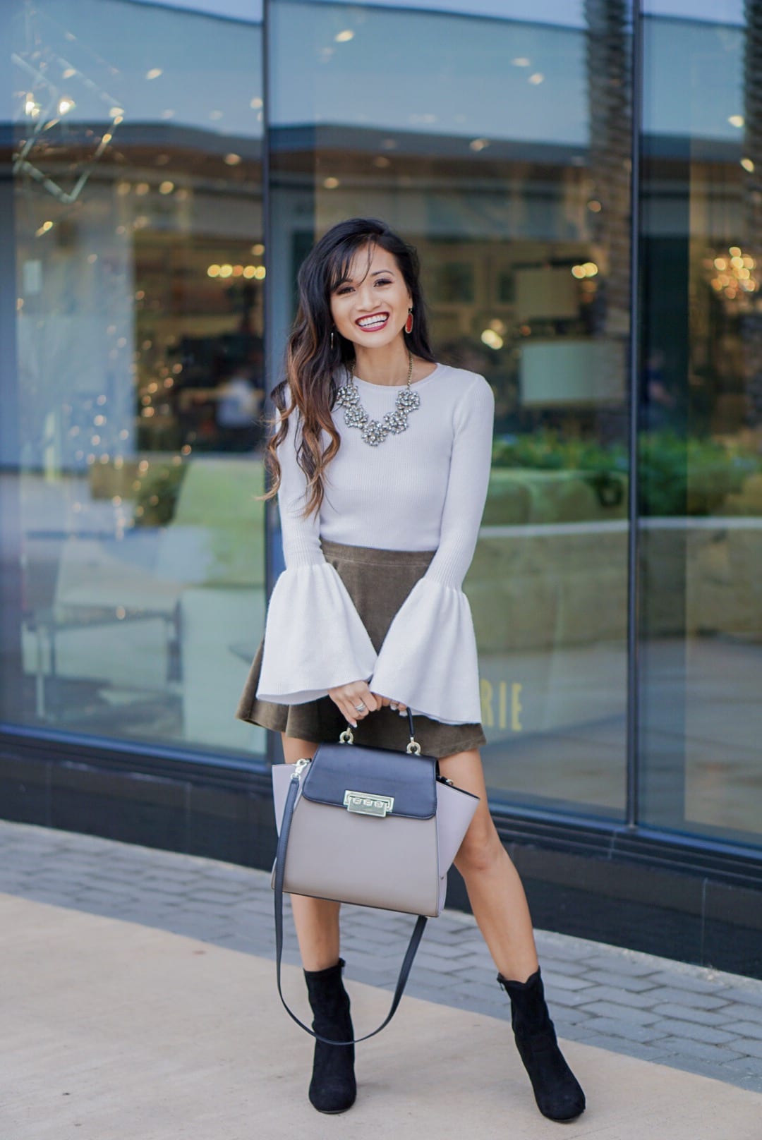 camel coat, corduroy skirt, black sock booties, winter outfit, white bell sleeve top, Zac Posen bag, red Kendra Scott earrings