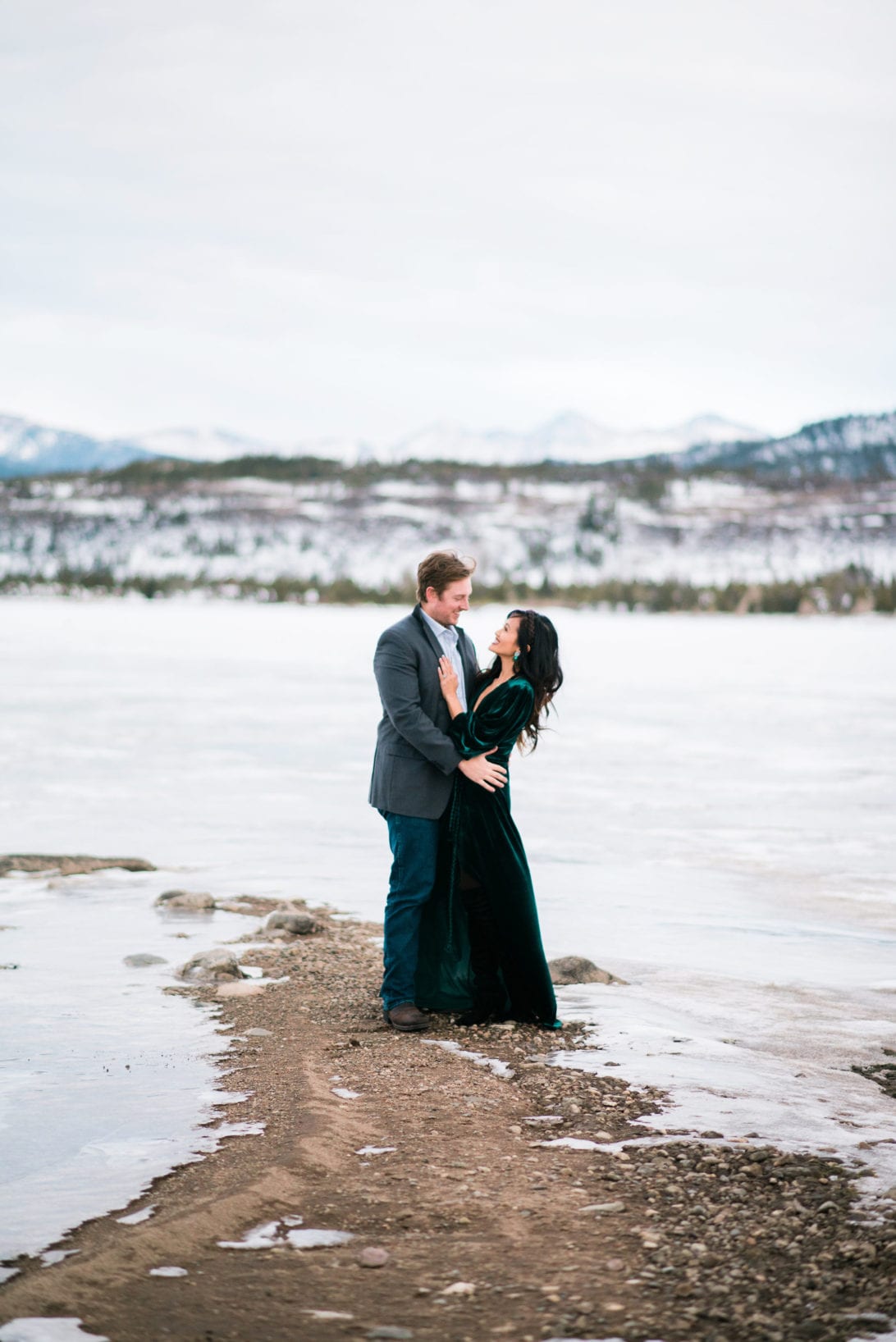 family pictures, snow family pictures, Colorado family pictures, frozen lake, christmas card family pictures, boy mom, green velvet dress, velvet dress, engagement pictures, couples pictures