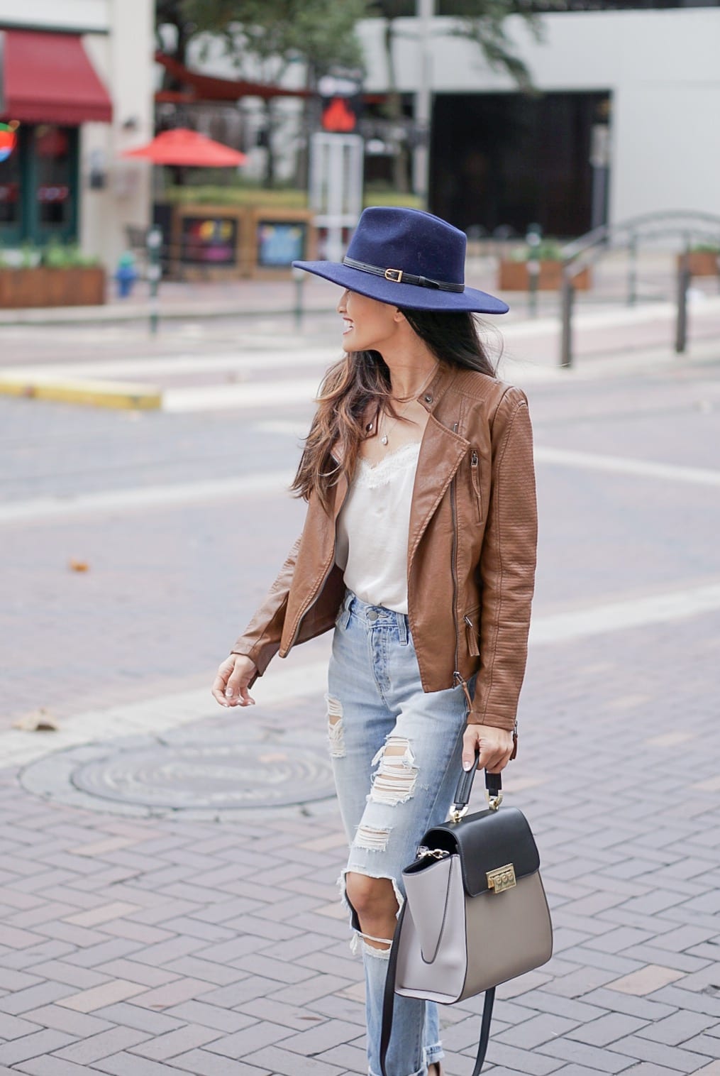 leather jacket, brown leather jacket, moto leather jacket, mom jeans, distressed jeans, navy felt hat, Steve Madden Carson sandal, white lace cami, Zac Zac Posen bag, spring outfit 