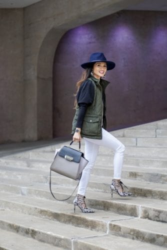 utility vest, green vest, Zac Posen bag, white jeans, white denim outfit, lace up heels, navy felt brim hat, red dress boutique, puff sleeves, bauble bar earrings, statement earrings, how to wear a vest, winter outfit, how to style a hat