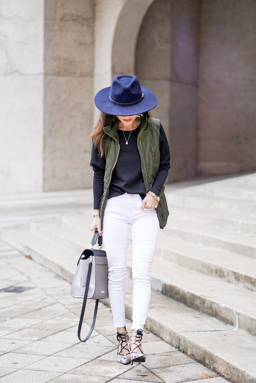 utility vest, green vest, Zac Posen bag, white jeans, white denim outfit, lace up heels, navy felt brim hat, red dress boutique, puff sleeves, bauble bar earrings, statement earrings, how to wear a vest, winter outfit, how to style a hat 