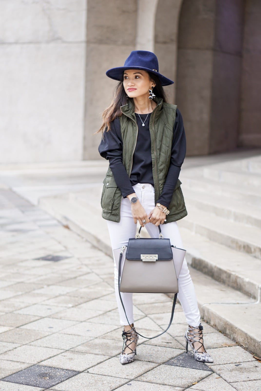 utility vest, green vest, Zac Posen bag, white jeans, white denim outfit, lace up heels, navy felt brim hat, red dress boutique, puff sleeves, bauble bar earrings, statement earrings, how to wear a vest, winter outfit, how to style a hat 