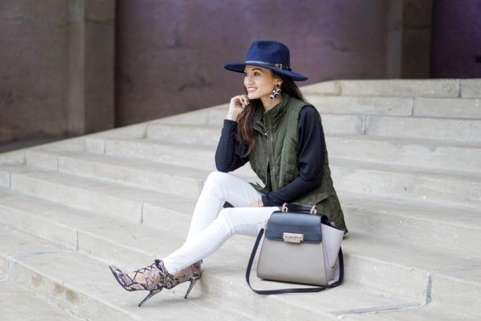 utility vest, green vest, Zac Posen bag, white jeans, white denim outfit, lace up heels, navy felt brim hat, red dress boutique, puff sleeves, bauble bar earrings, statement earrings, how to wear a vest, winter outfit, how to style a hat 