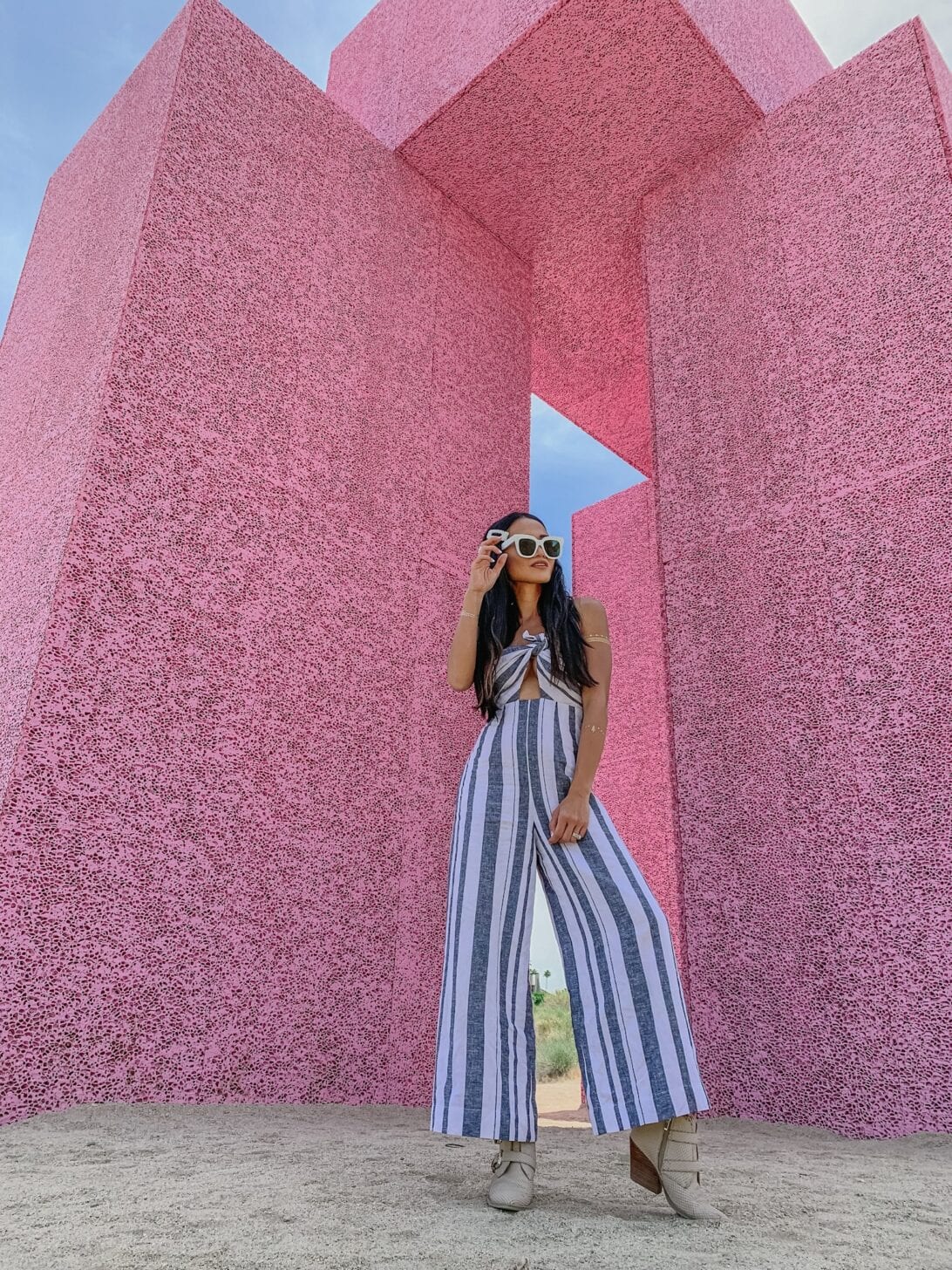 PINK WALL, JUMPSUIT, WHITE SUNGLASSES 