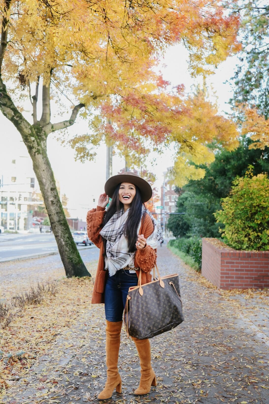 Louis Vuitton Neverfull, brown fedora, orange cardigan, Stuart Weitzman Hiline boots, over the knee boots, scarf , Seattle fall trees