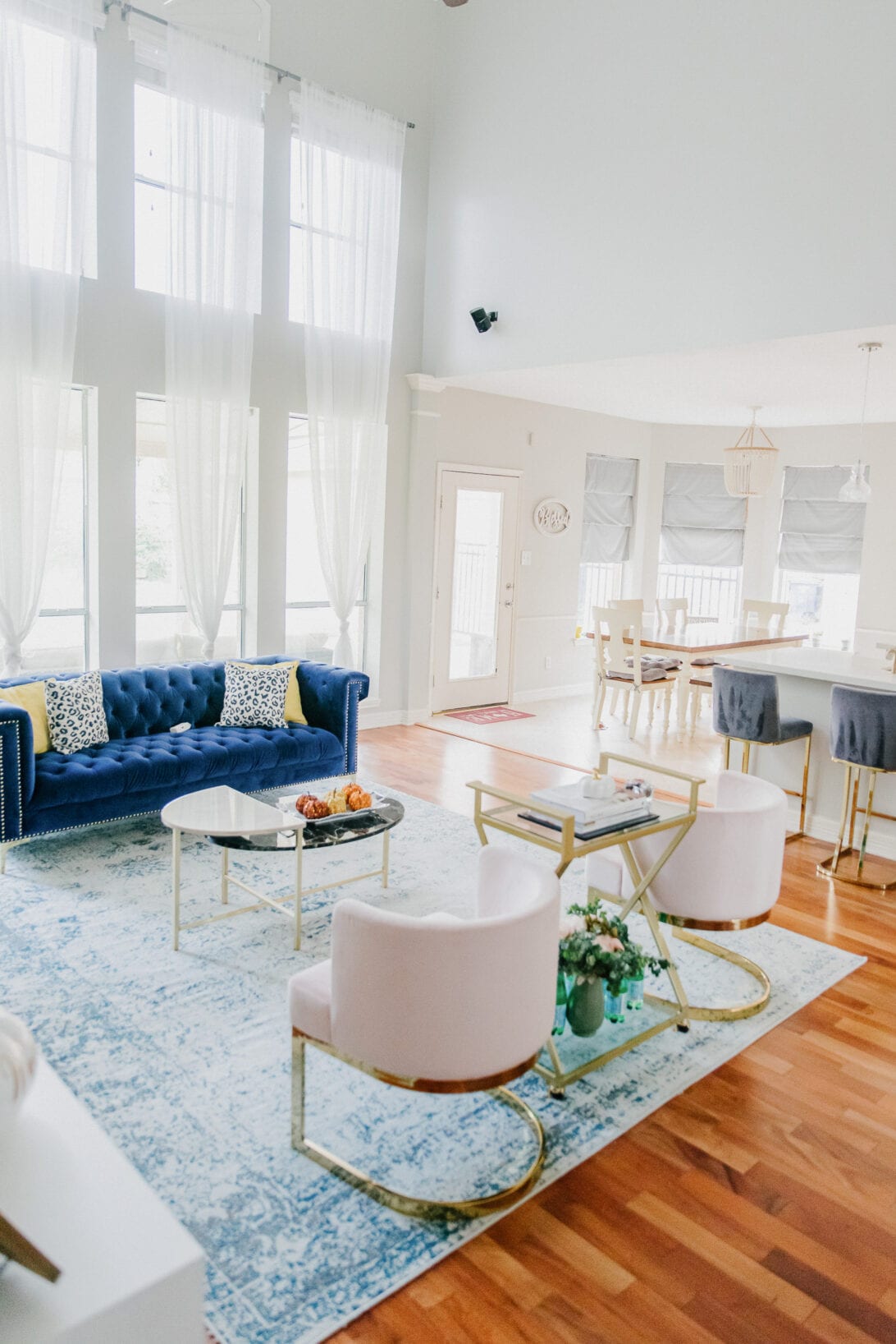 blue couch, pink glam chairs, glam living room 