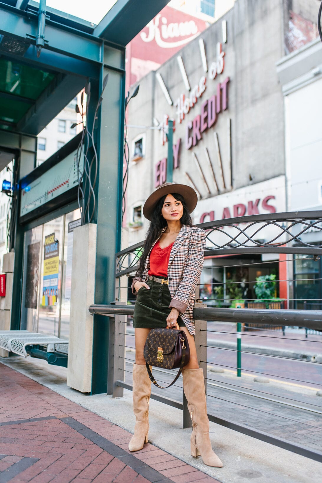 Louis Vuitton shoulder bag, green mini skirt, tan knee high boots, fall outfit, fall style 