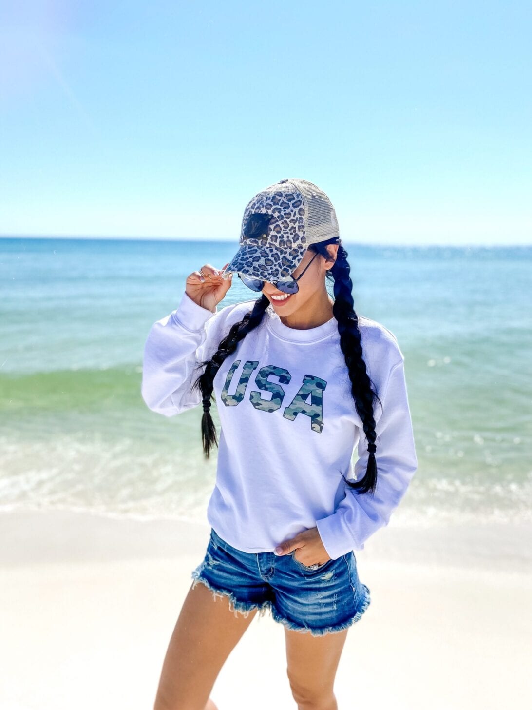 USA sweatshirt, denim cut off shorts, Quay sunglasses 