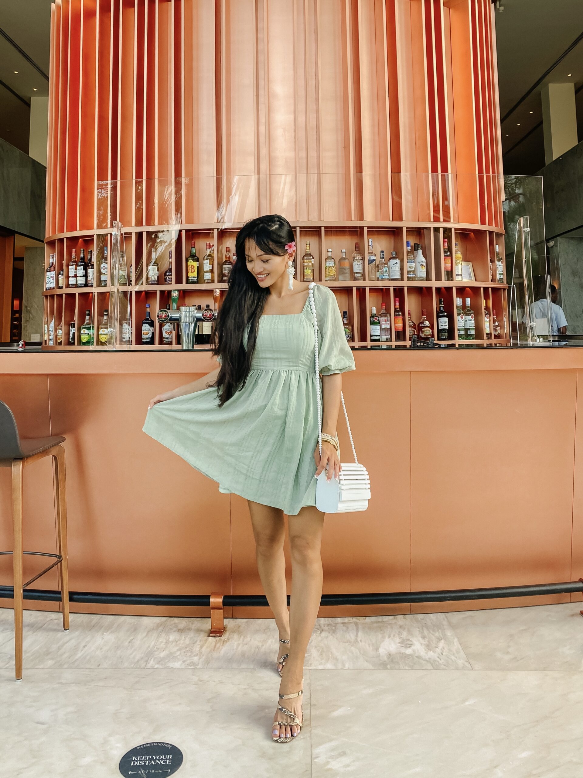 green dress, white beaded crossbody bag 