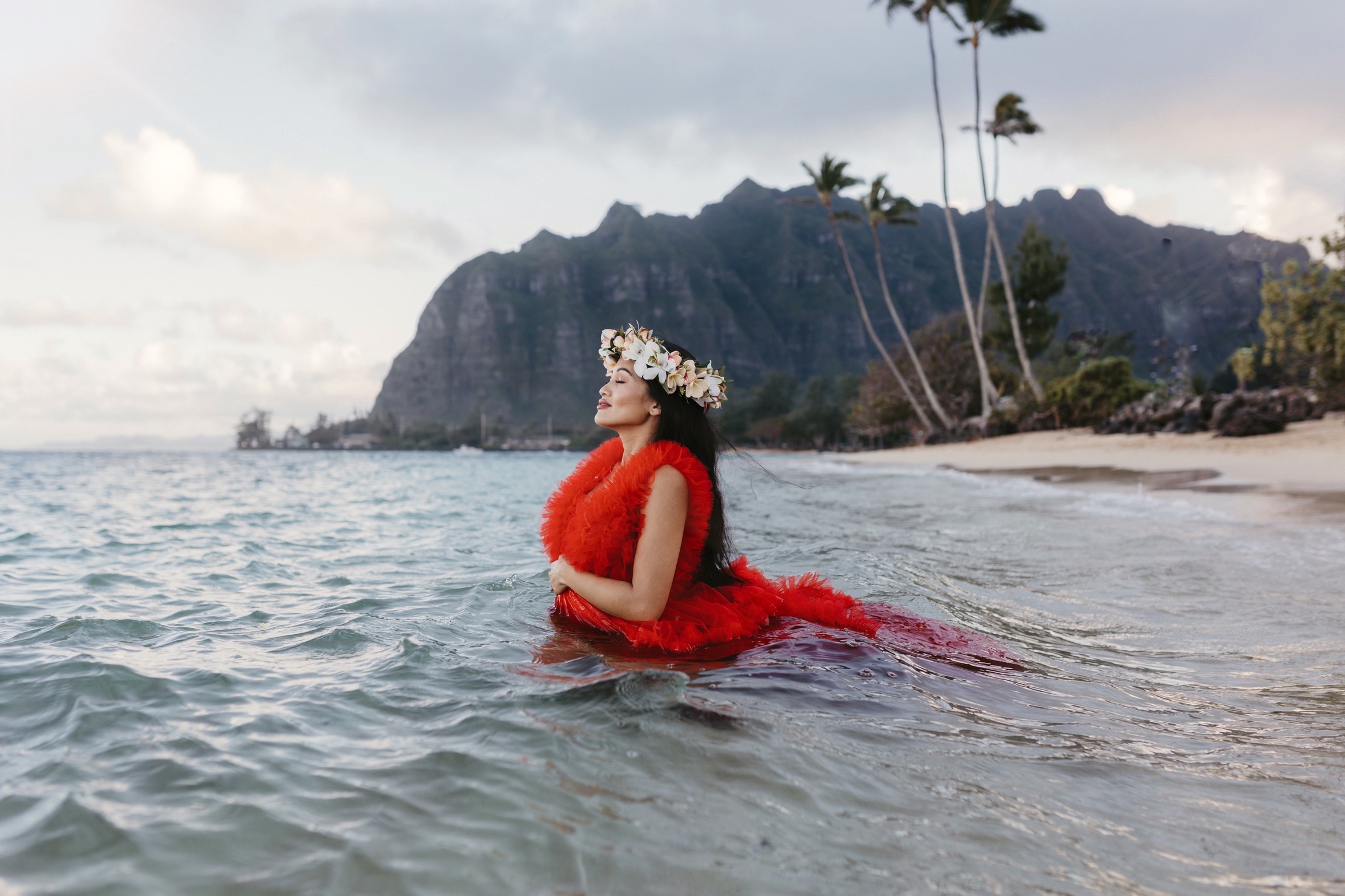 haku lei, red dress, maternity shoots, maternity dress, beach photoshoot 