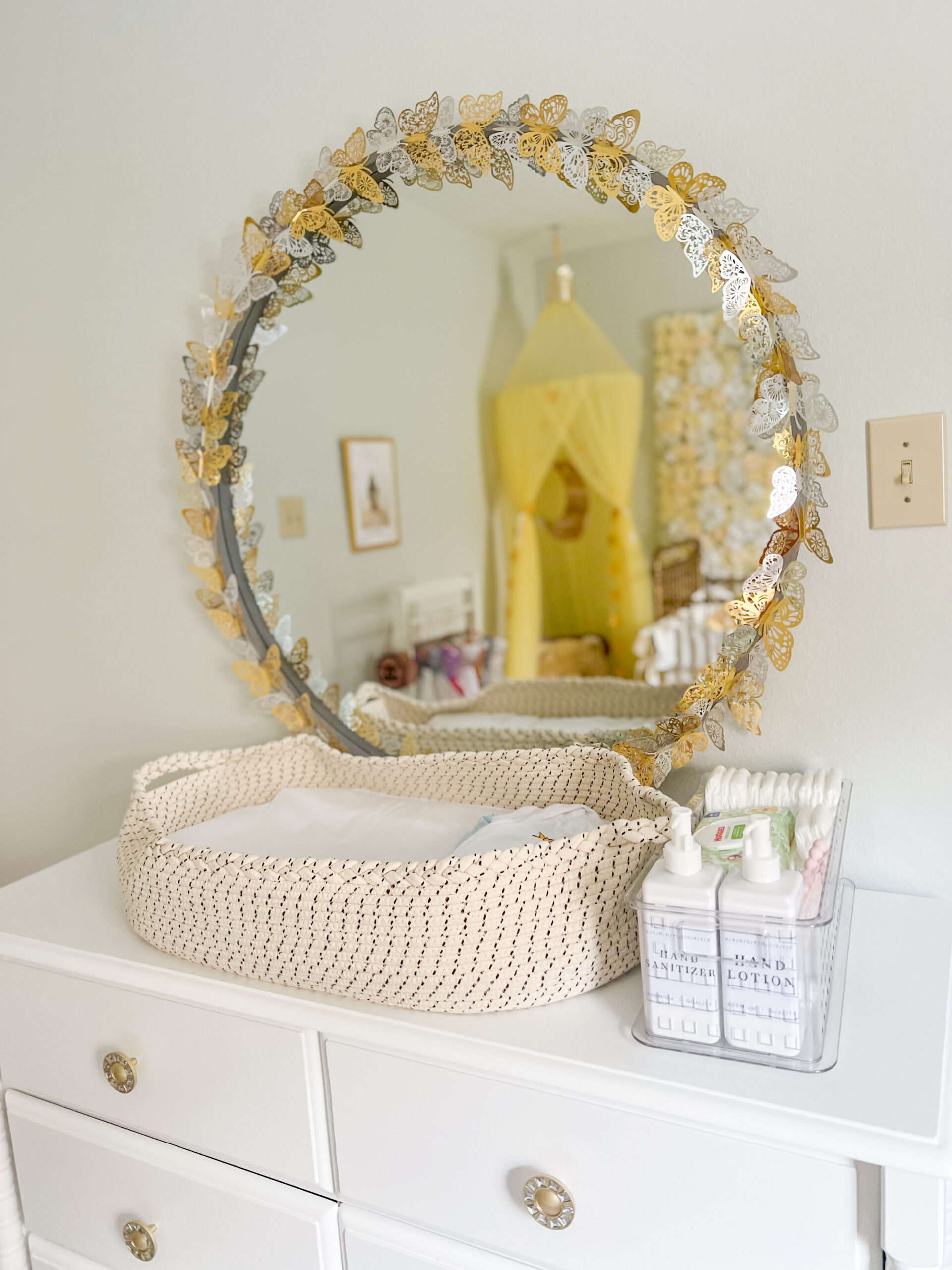 nursery, changing table, round gold mirror, butterfly mirror, DaVinci Jenny Lind Dresser, changing station, woven changing basket 