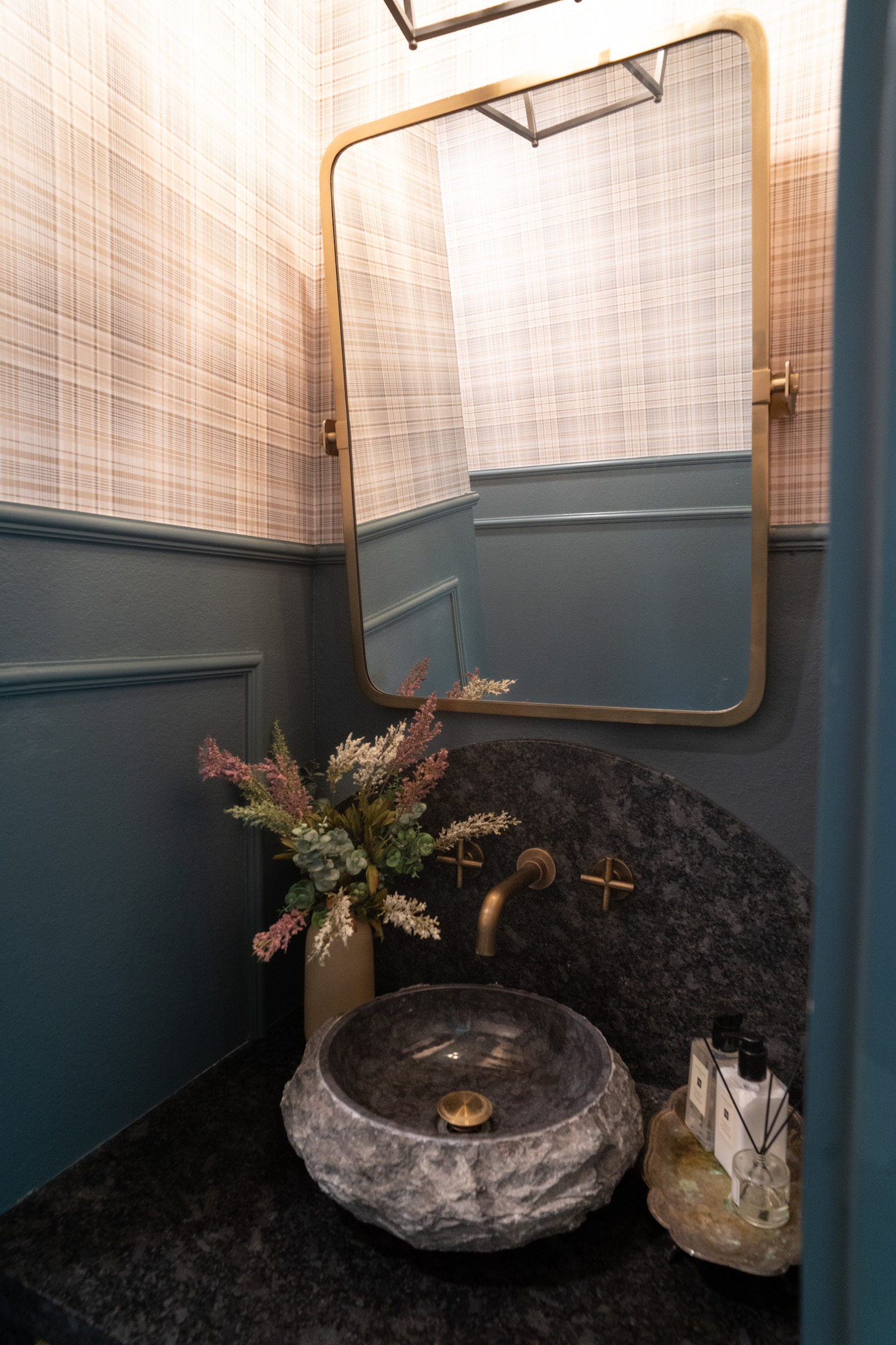 vessel sink, dark blue wall color, black sink, plaid wallpaper 